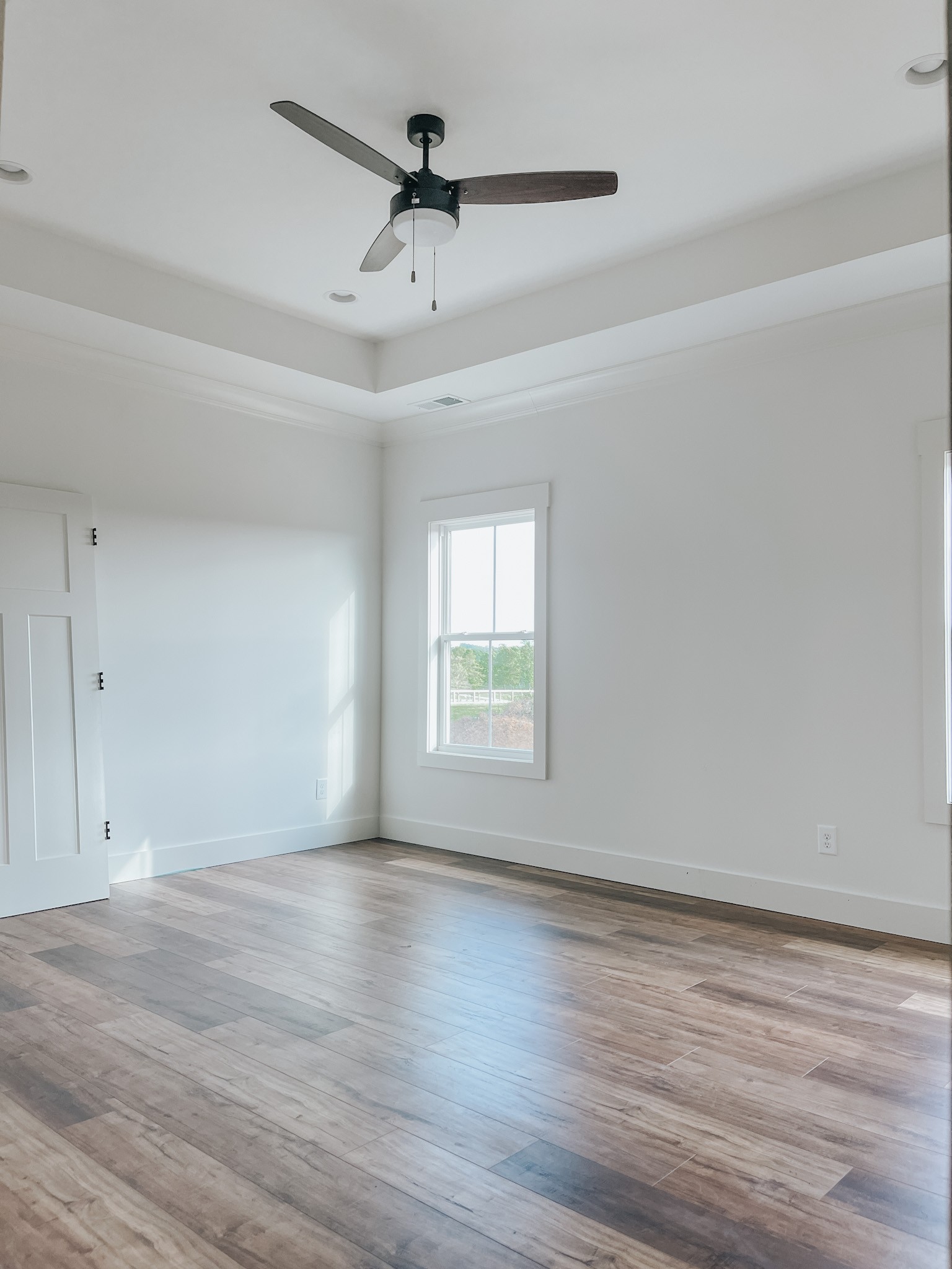 1402 Fowler Ford Road Portland, TN 37148 - Photo 17 of 27 a view of an empty room with wooden floor and a window