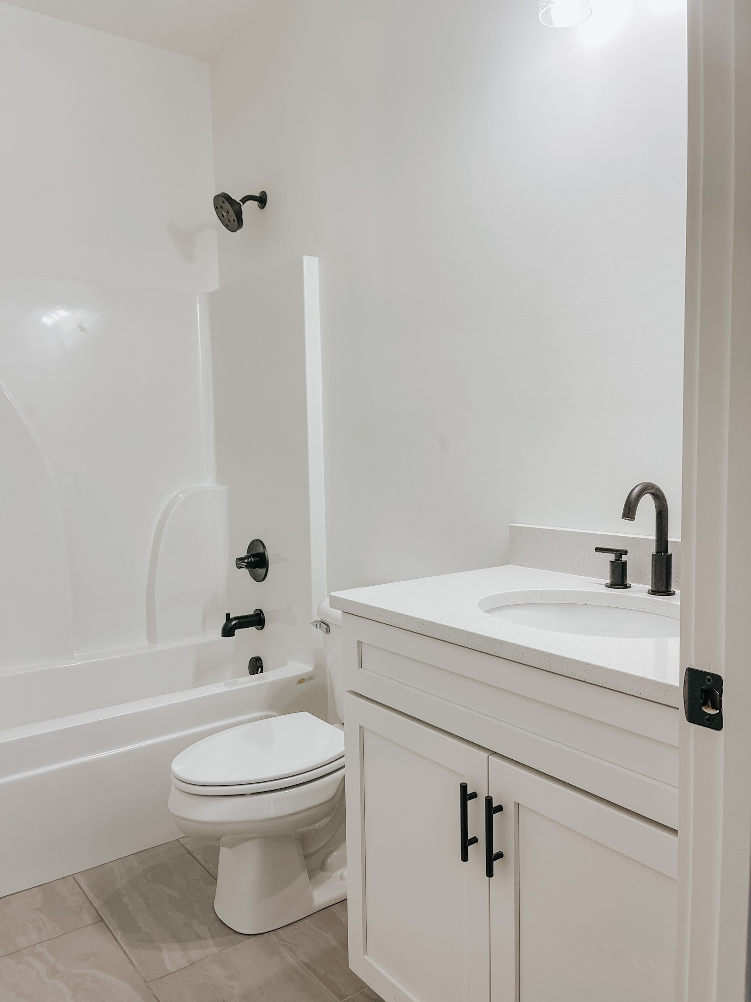 1402 Fowler Ford Road Portland, TN 37148 - Photo 25 of 27 a bathroom with a white toilet sitting next to a bathroom sink and a shower