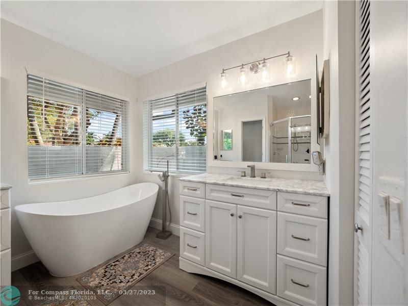 a spacious bathroom with a large tub and sink