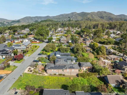 an aerial view of residential house with green space