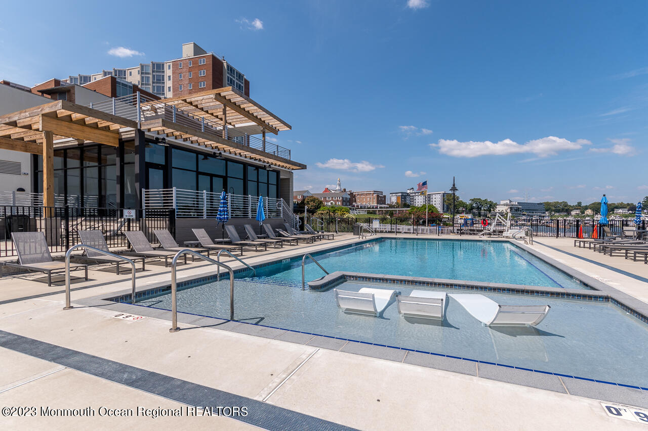 28 Riverside Avenue, Unit 4J Red Bank, NJ 07701 - Photo 16 of 18 a view of swimming pool with outdoor seating and city view