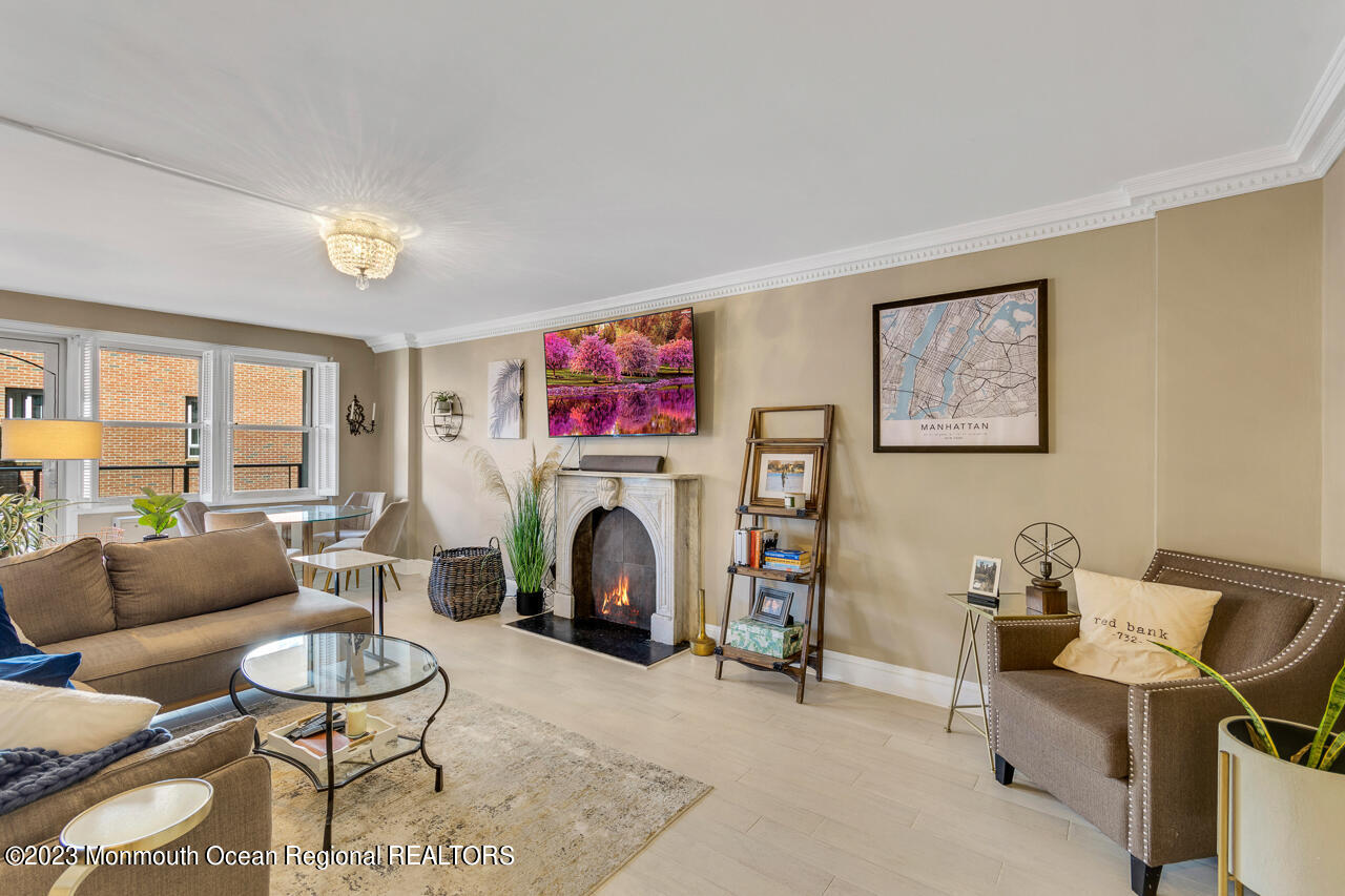 28 Riverside Avenue, Unit 4J Red Bank, NJ 07701 - Photo 4 of 18 a living room with furniture a window and a fireplace