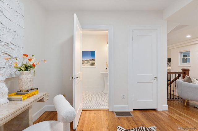 a bathroom with a sink and mirror with toilet