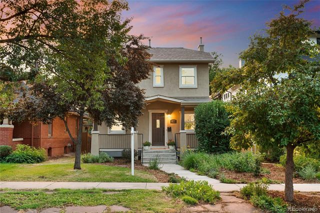 an aerial view of multiple houses with a yard