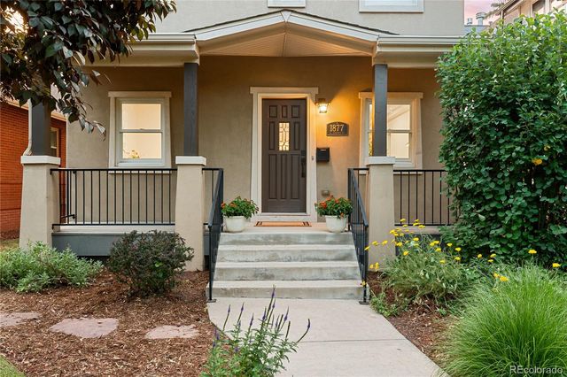 a view of a house with a yard and sitting area