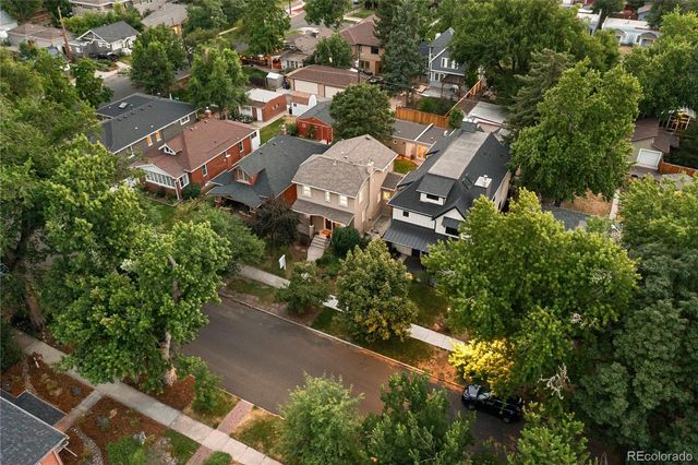 an aerial view of residential houses with city view