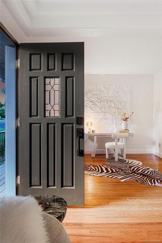 a view of entryway and hall with wooden floor
