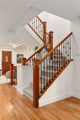 a living room with furniture kitchen view and a wooden floor