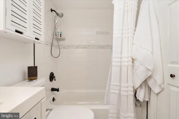 a bathroom with a bathtub and shower