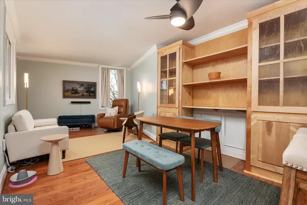 a living room with furniture a rug and a window