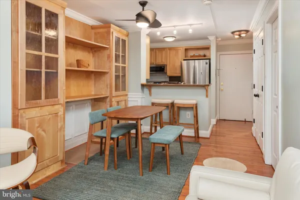 a living room with furniture a flat screen tv and kitchen view