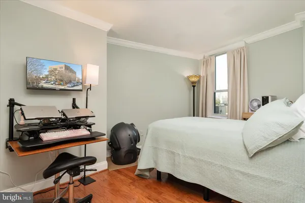 a bedroom with a bed and a desk