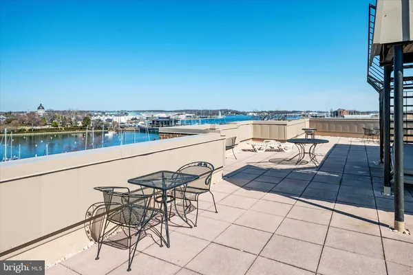 a view of swimming pool with outdoor seating and city view