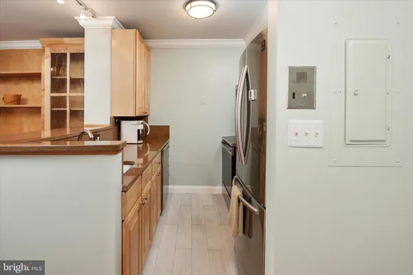 a kitchen with a refrigerator and a sink