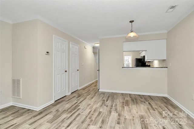 a view of a kitchen with wooden floor and a sink