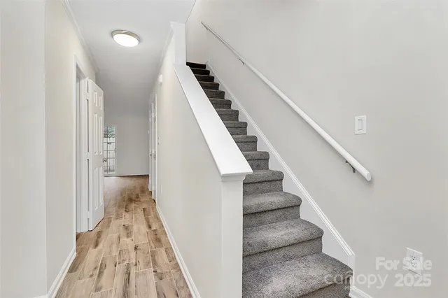 a view of entryway and hall with wooden floor