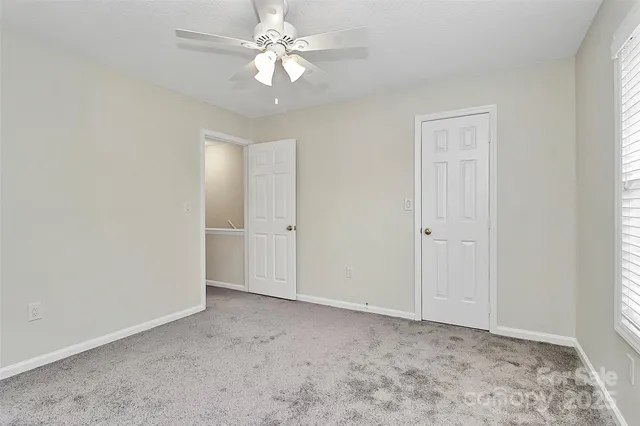 a view of an empty room with a fan