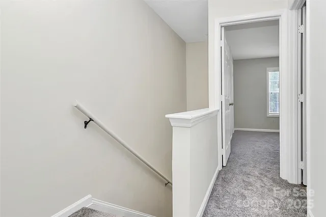 a view of a hallway view with staircase