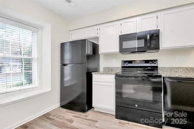 a kitchen with stainless steel appliances a refrigerator microwave and sink
