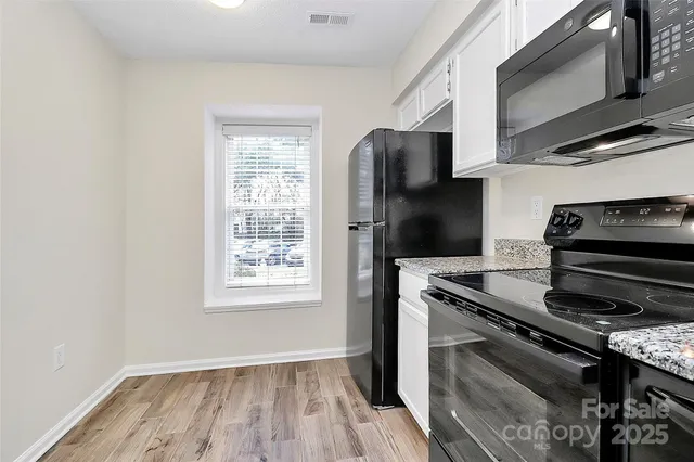 a kitchen with a stove microwave and refrigerator