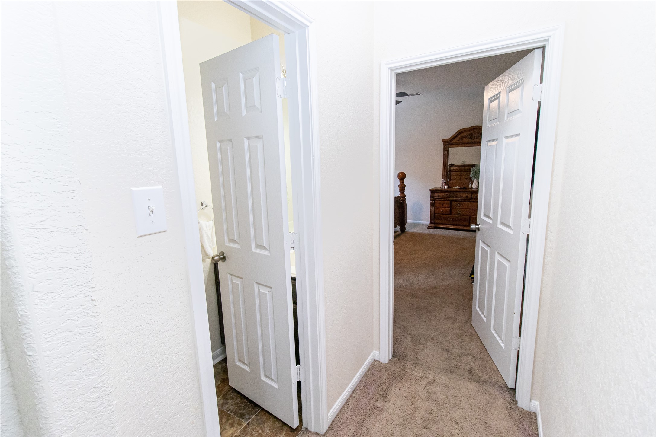 8222 Pastel Dawn Trace Houston, TX 77049 - Photo 11 of 35 a view of a hallway with a closet and a bathroom