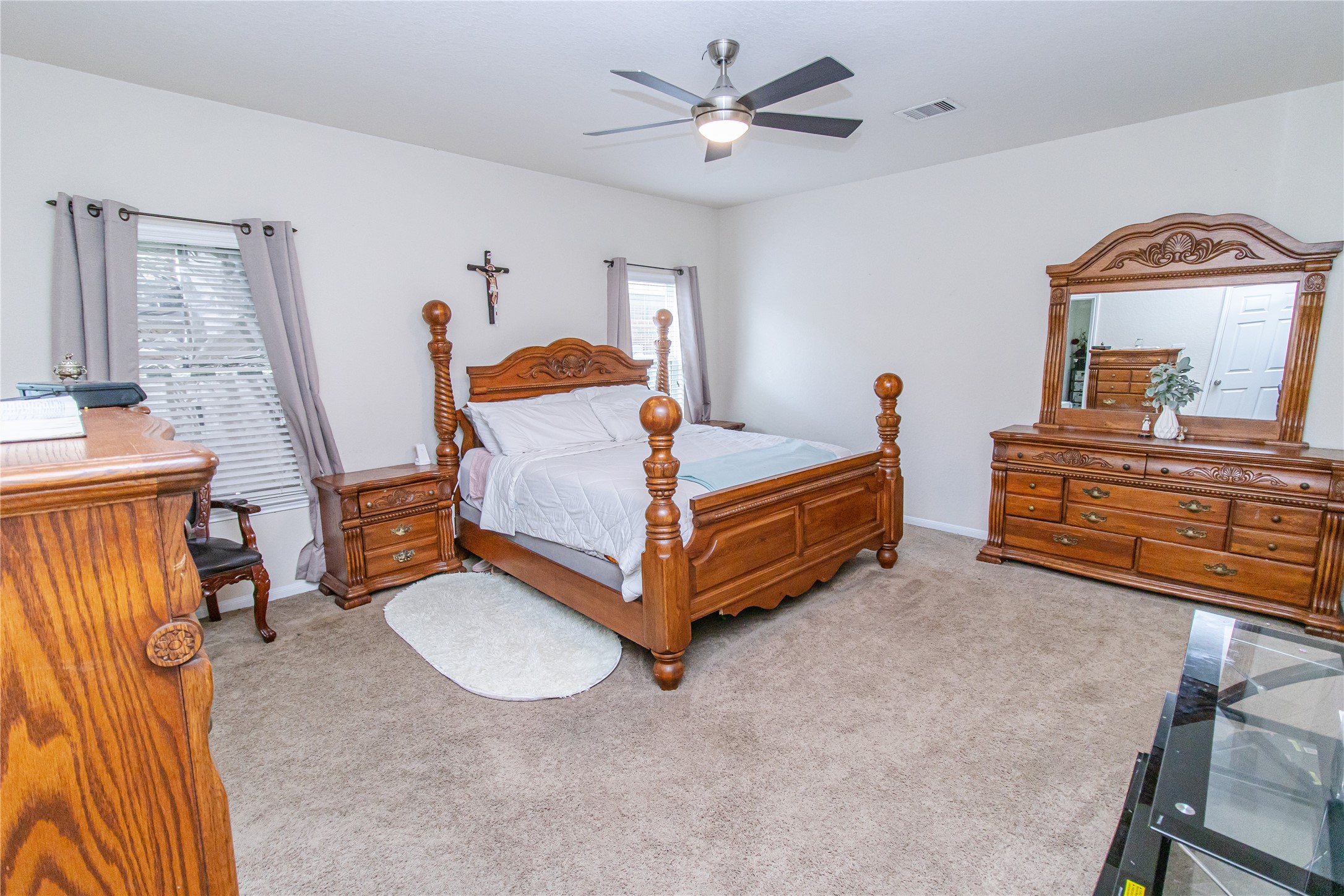 8222 Pastel Dawn Trace Houston, TX 77049 - Photo 18 of 35 a bedroom with a bed and a chandelier