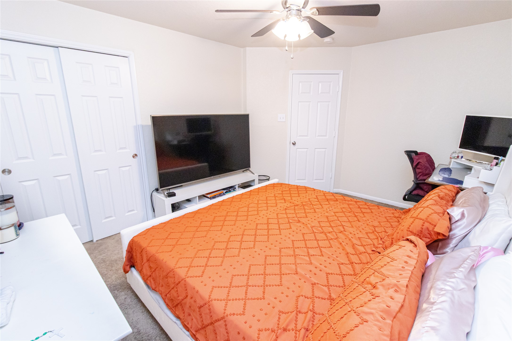 8222 Pastel Dawn Trace Houston, TX 77049 - Photo 22 of 35 a bedroom with a bed and a flat screen tv