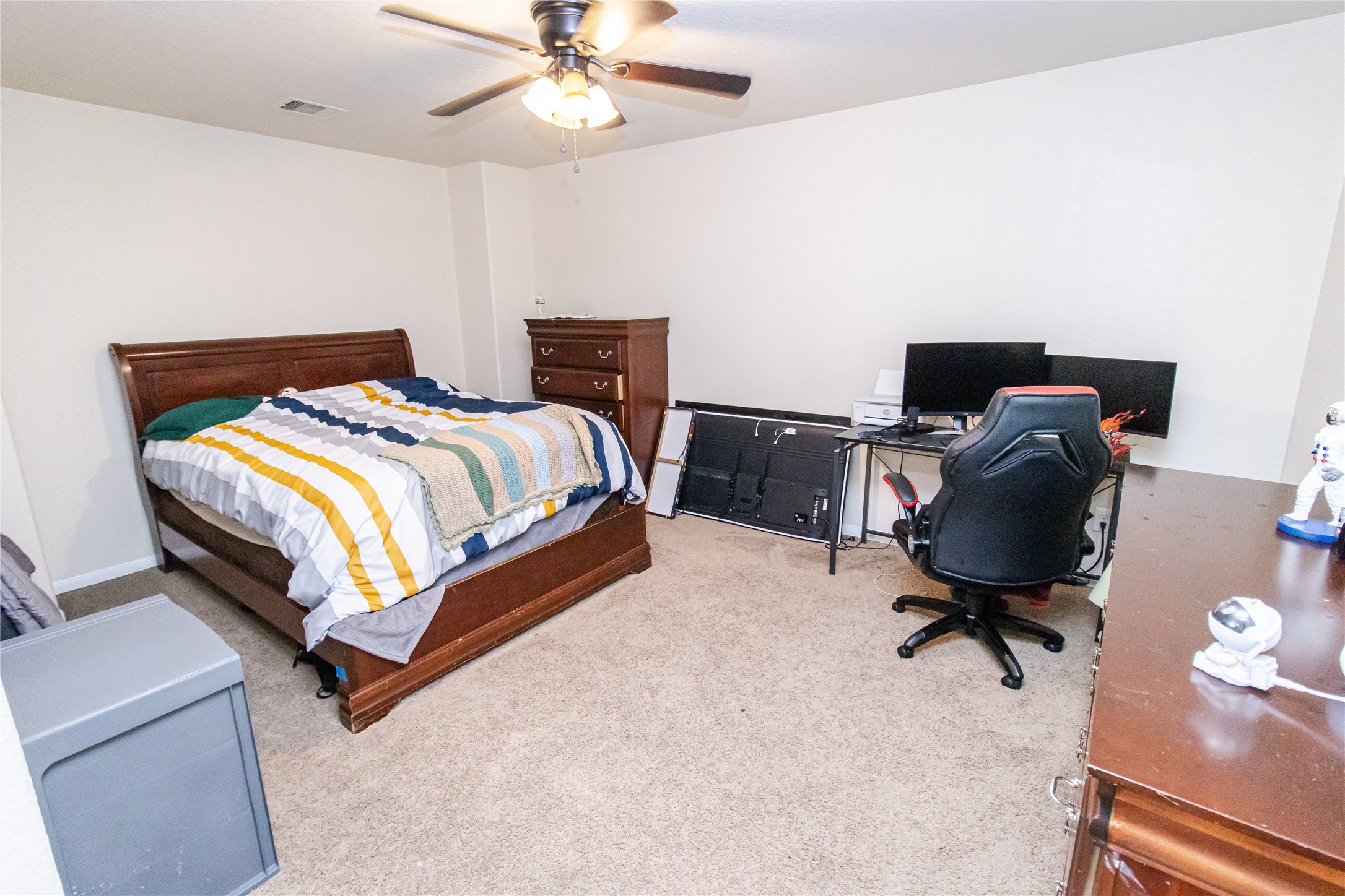 8222 Pastel Dawn Trace Houston, TX 77049 - Photo 23 of 35 a bedroom with a bed and a chandelier