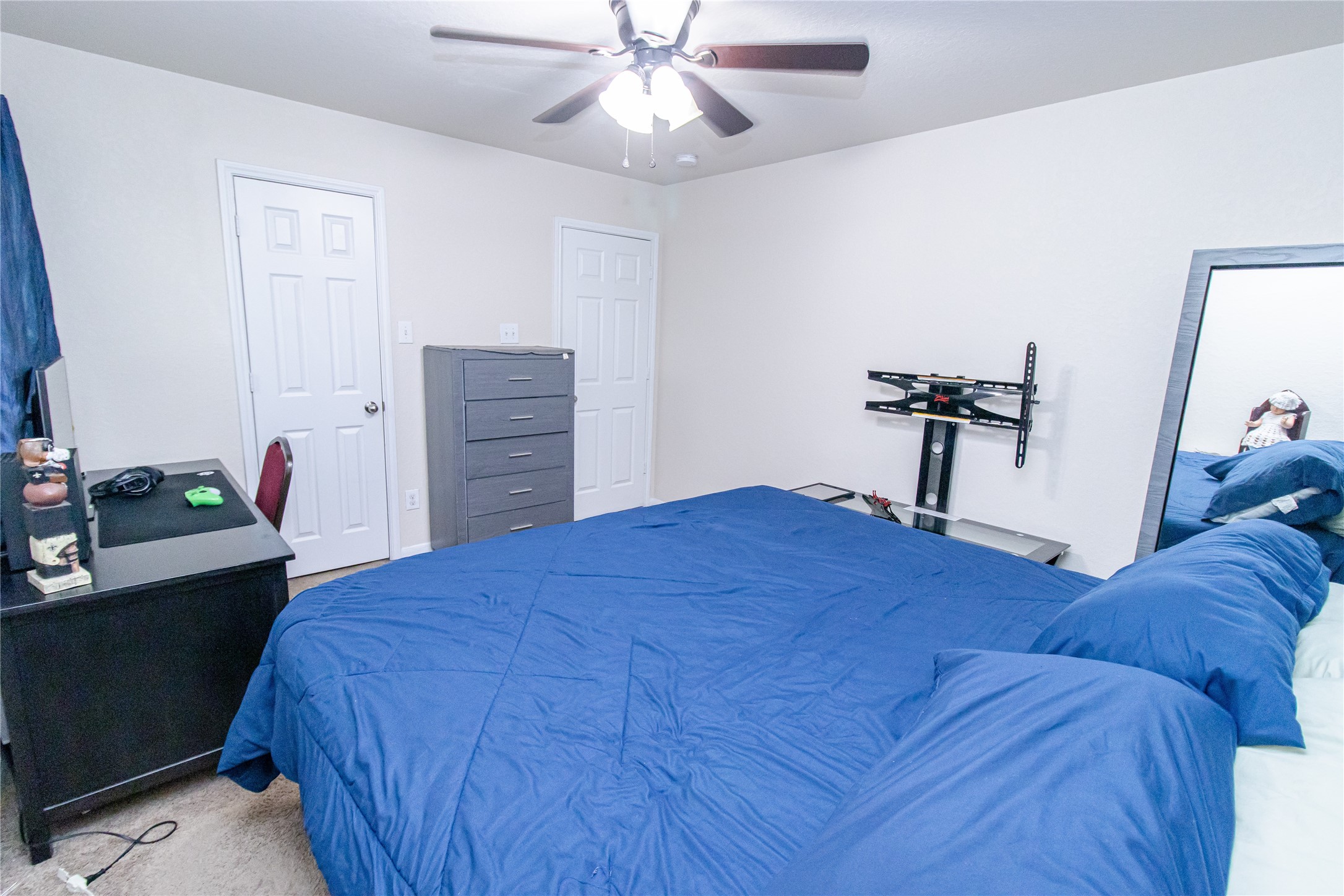 8222 Pastel Dawn Trace Houston, TX 77049 - Photo 25 of 35 a bedroom with a bed and a chandelier