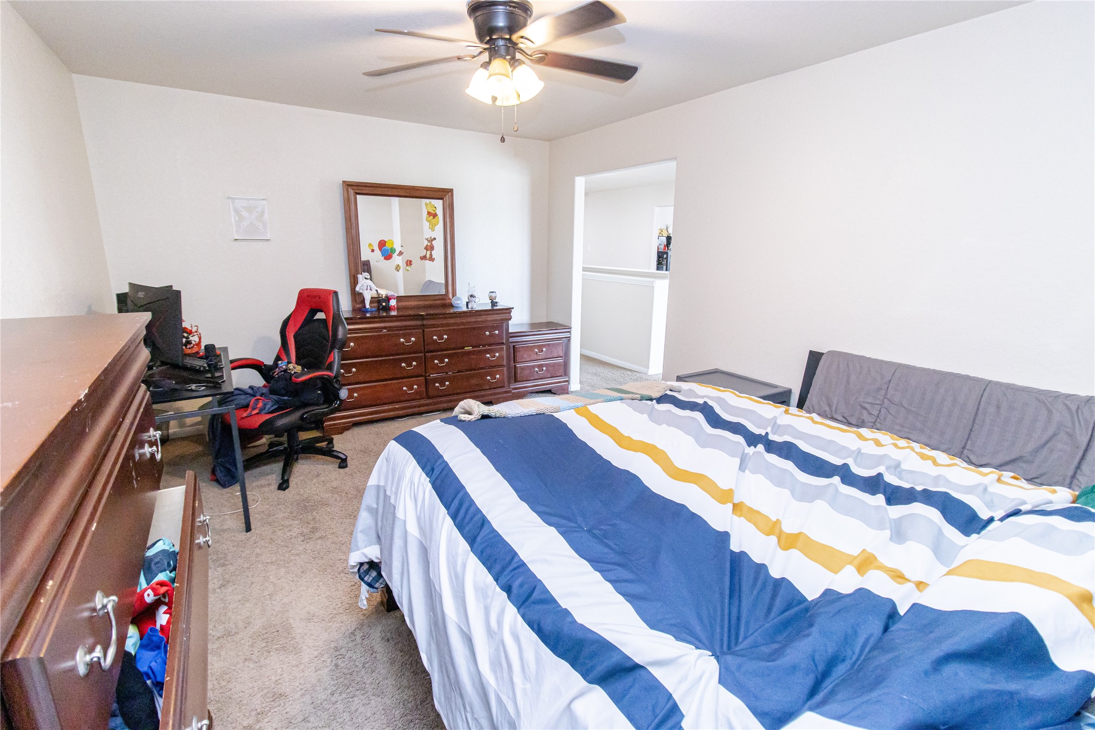 8222 Pastel Dawn Trace Houston, TX 77049 - Photo 31 of 35 a bedroom with bed and a chandelier