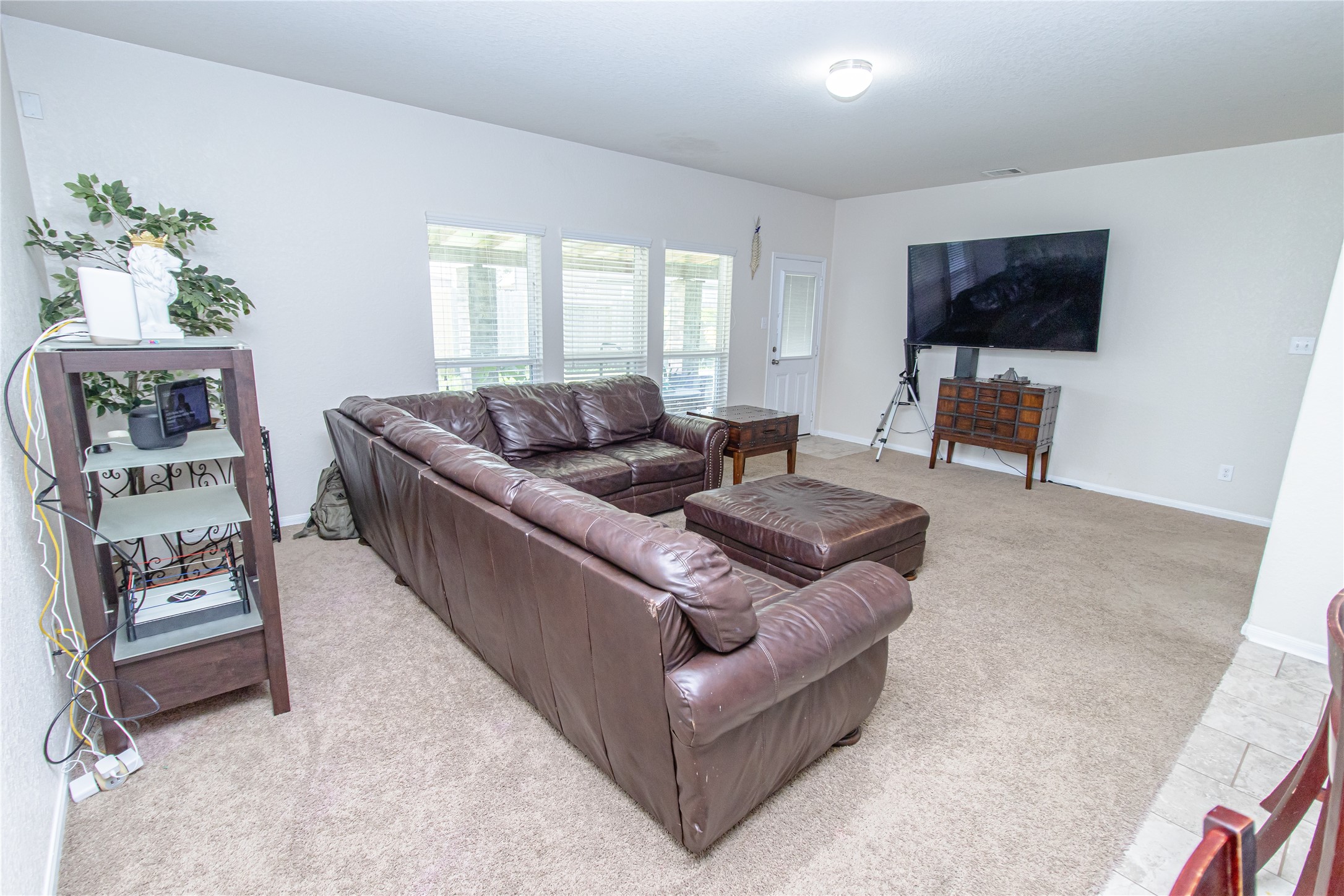 8222 Pastel Dawn Trace Houston, TX 77049 - Photo 34 of 35 a living room with furniture and a flat screen tv