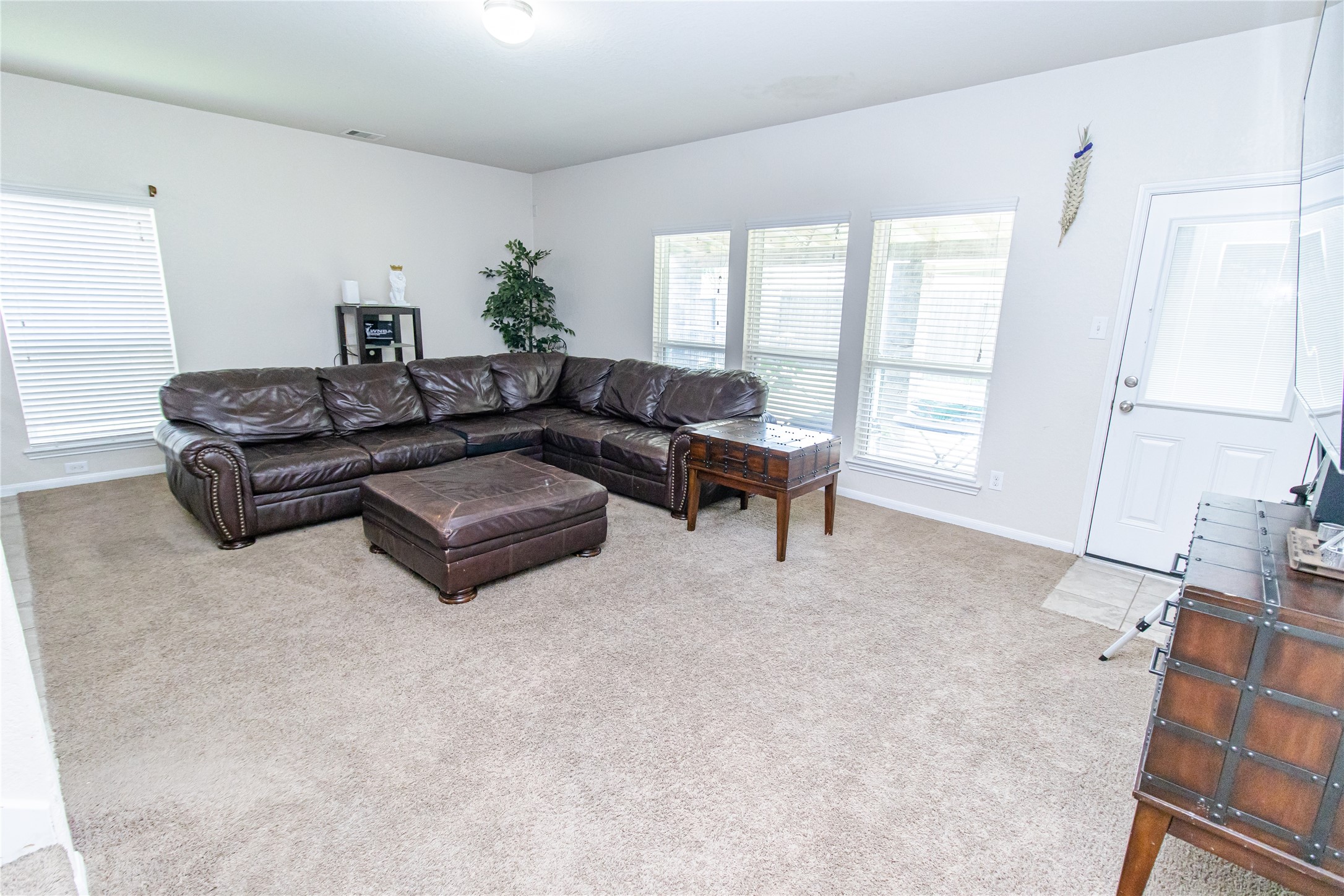 8222 Pastel Dawn Trace Houston, TX 77049 - Photo 7 of 35 a living room with furniture and a flat screen tv