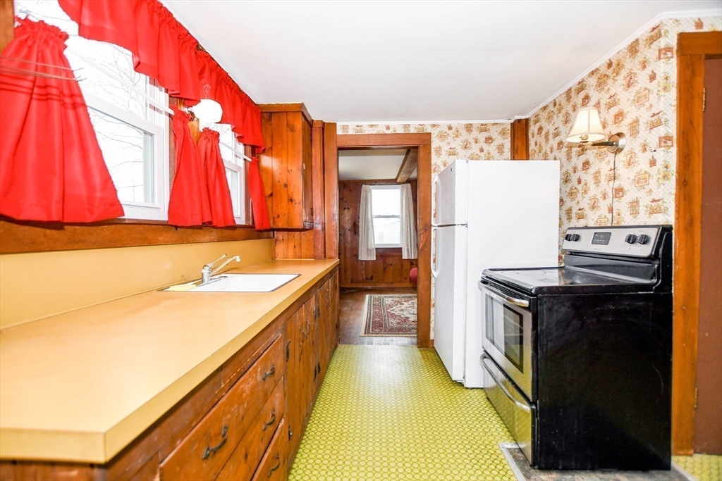 10 Converse Road Marion, MA 02738 - Photo 13 of 33 a kitchen with a sink a stove and a refrigerator