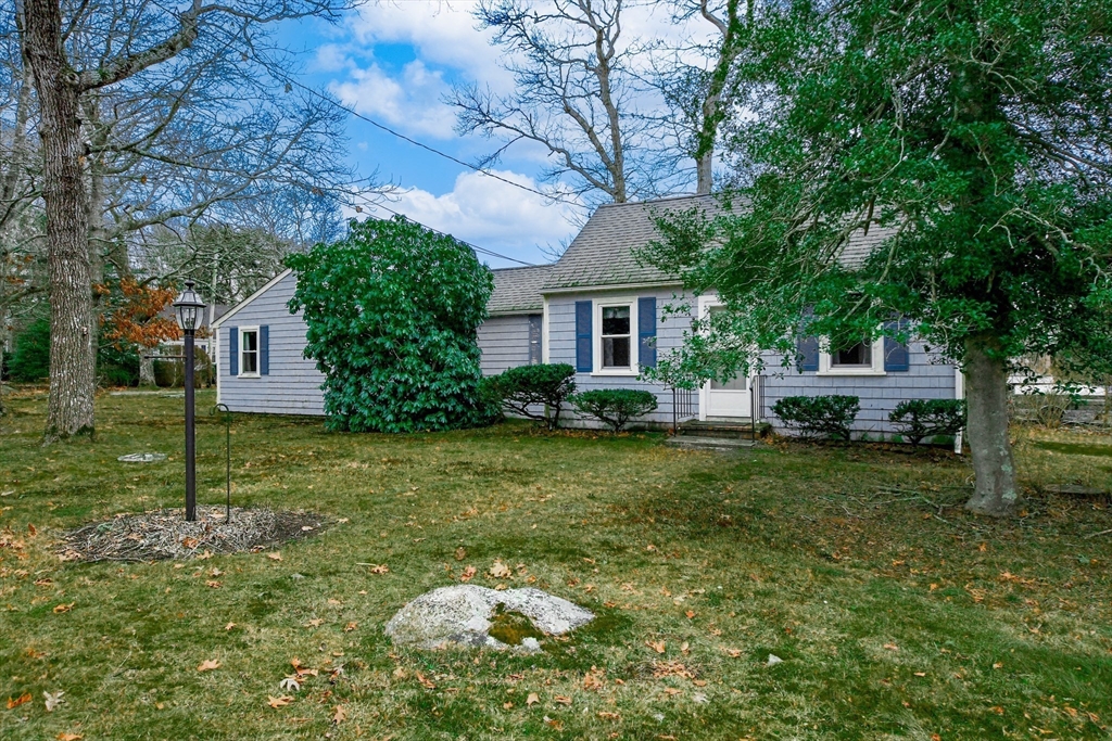 10 Converse Road Marion, MA 02738 - Photo 2 of 33 a backyard of a house with table and chairs plants and large tree