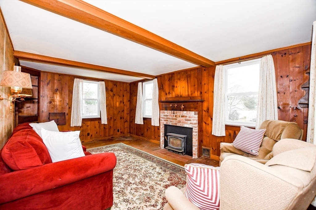 10 Converse Road Marion, MA 02738 - Photo 9 of 33 a living room with furniture a fireplace and a floor to ceiling window