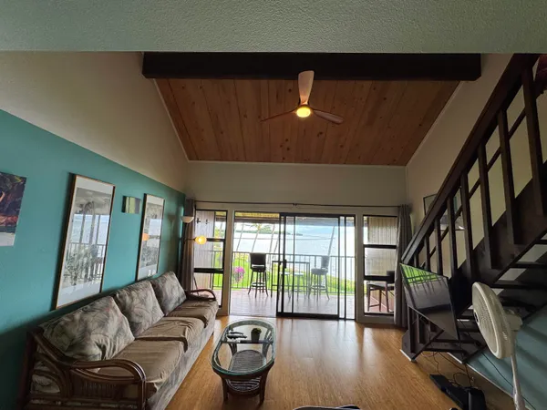 a living room with furniture and a floor to ceiling window