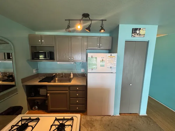 a kitchen with stainless steel appliances granite countertop a refrigerator and a stove