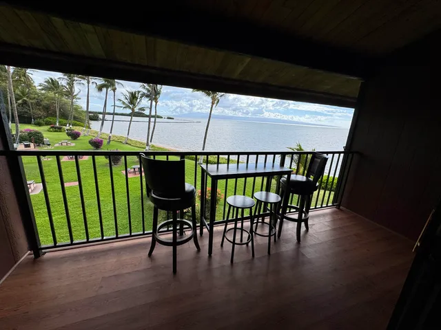 a view of a patio with a table chairs and a backyard