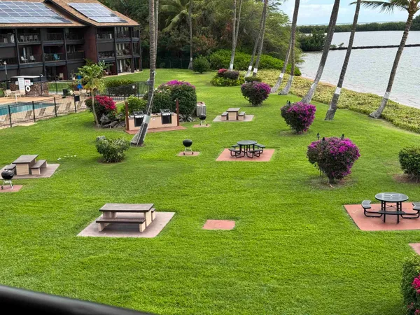 a view of a table and chairs in backyard of house