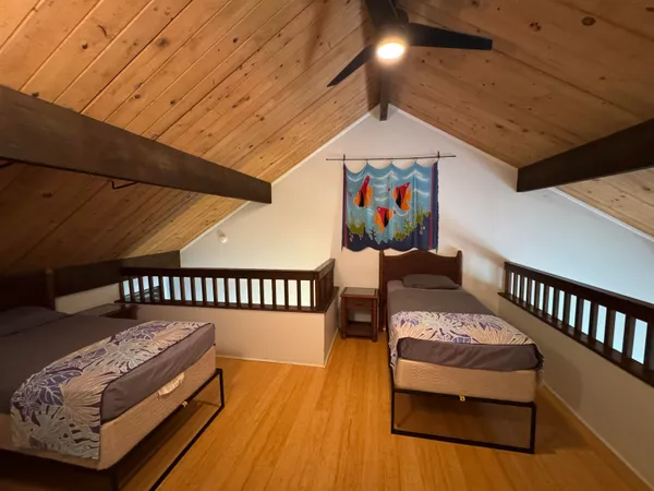 a bedroom with furniture and a wooden floor