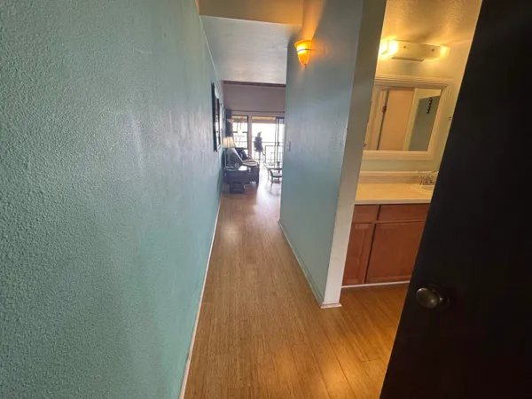 view of a hallway with wooden floor