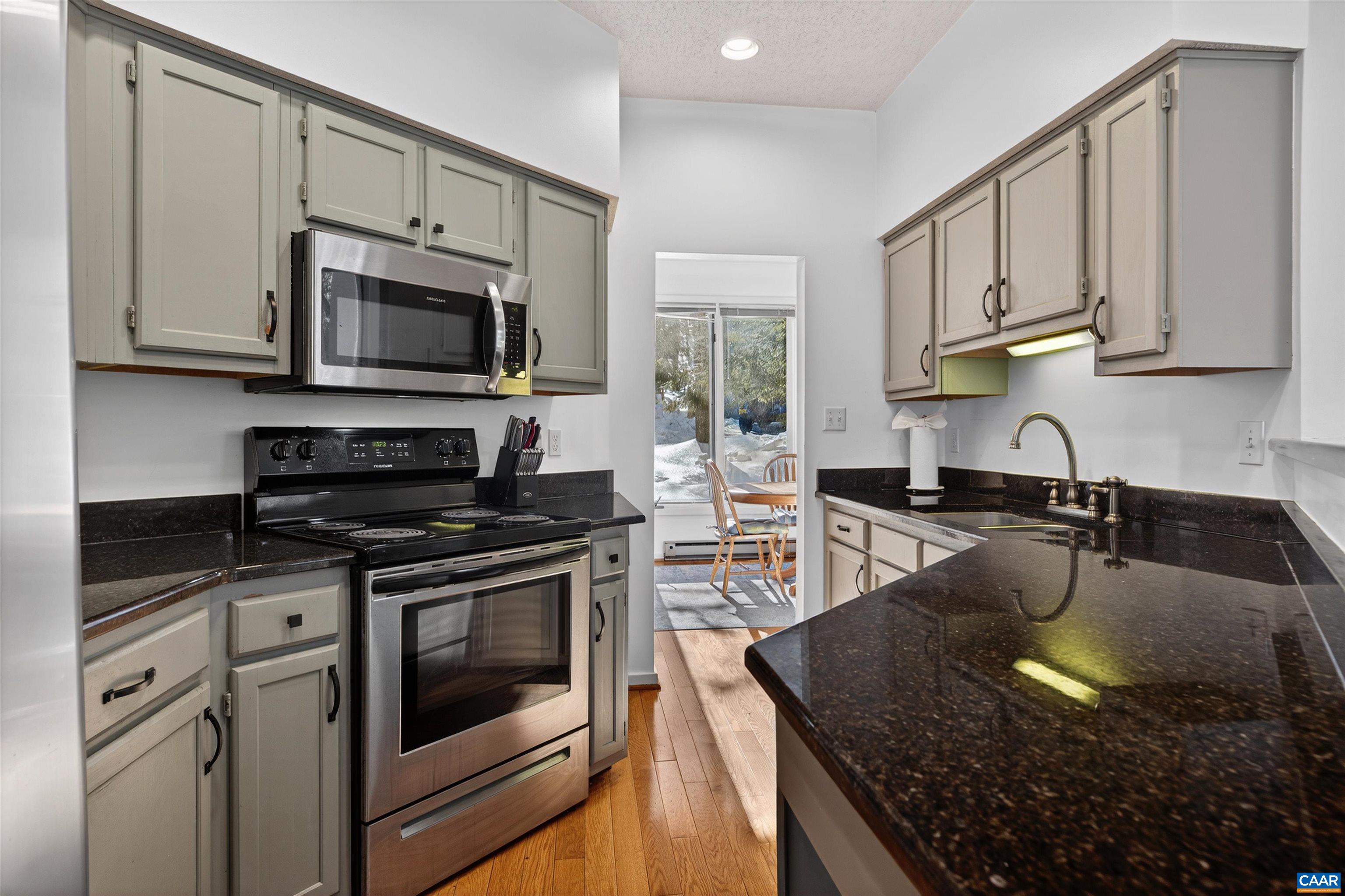 22 Trillium Cl Roseland, VA 22967 - Photo 11 of 35 a kitchen with stainless steel appliances granite countertop a sink stove and microwave