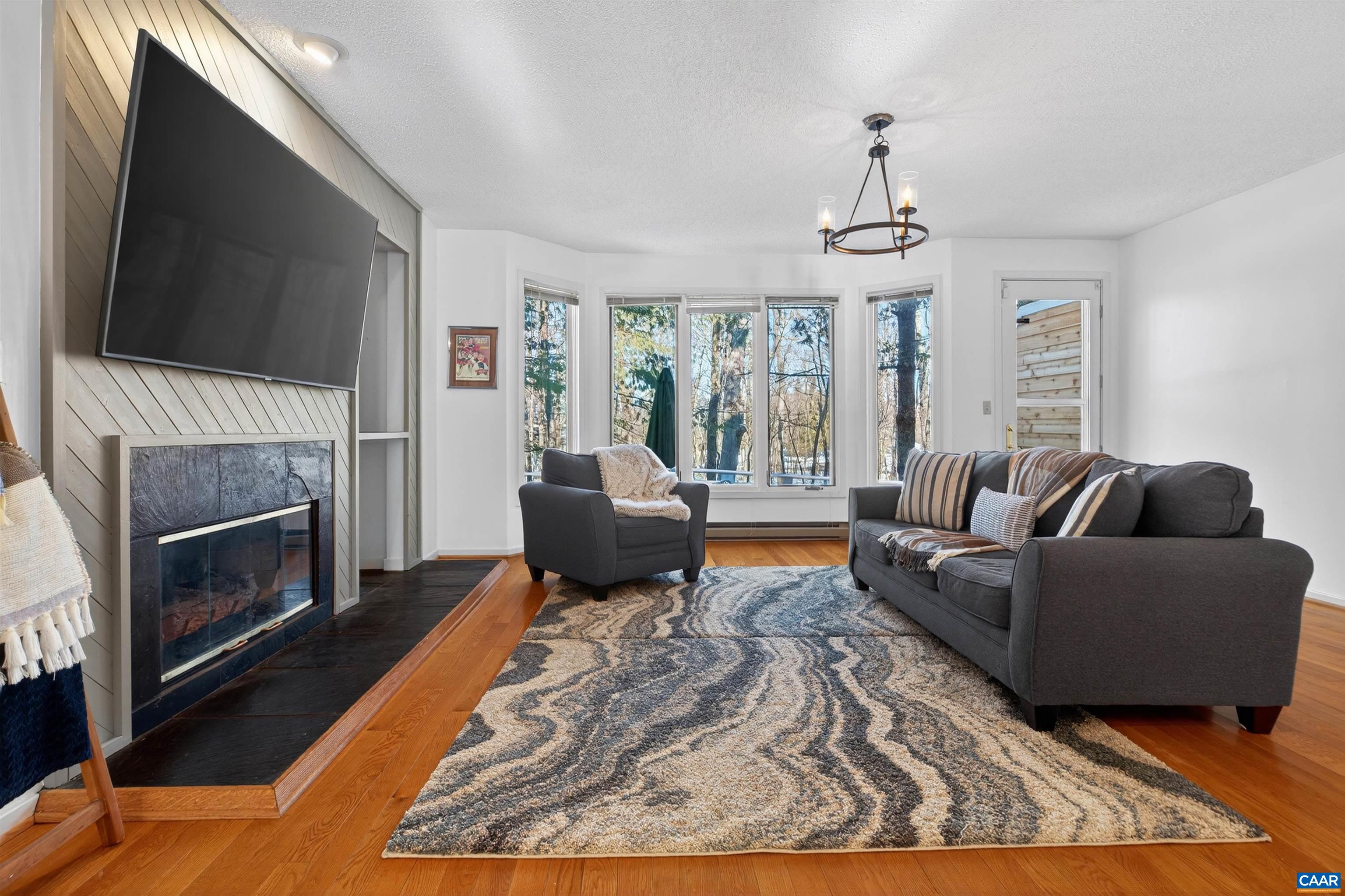 22 Trillium Cl Roseland, VA 22967 - Photo 3 of 35 a living room with furniture a flat screen tv and a fireplace