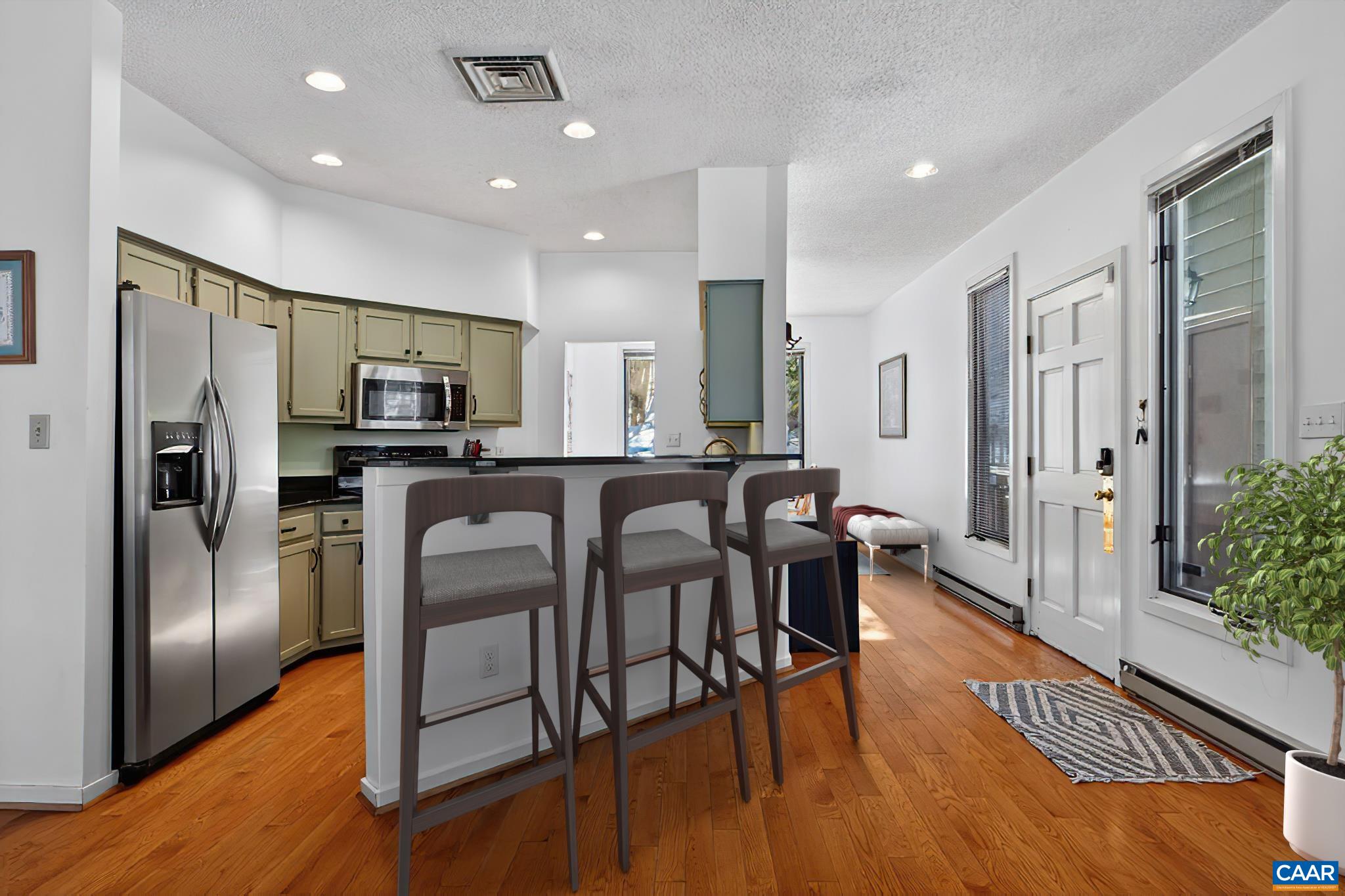 22 Trillium Cl Roseland, VA 22967 - Photo 10 of 35 a kitchen with stainless steel appliances a refrigerator a stove top oven a sink dishwasher a dining table and chairs with wooden floor