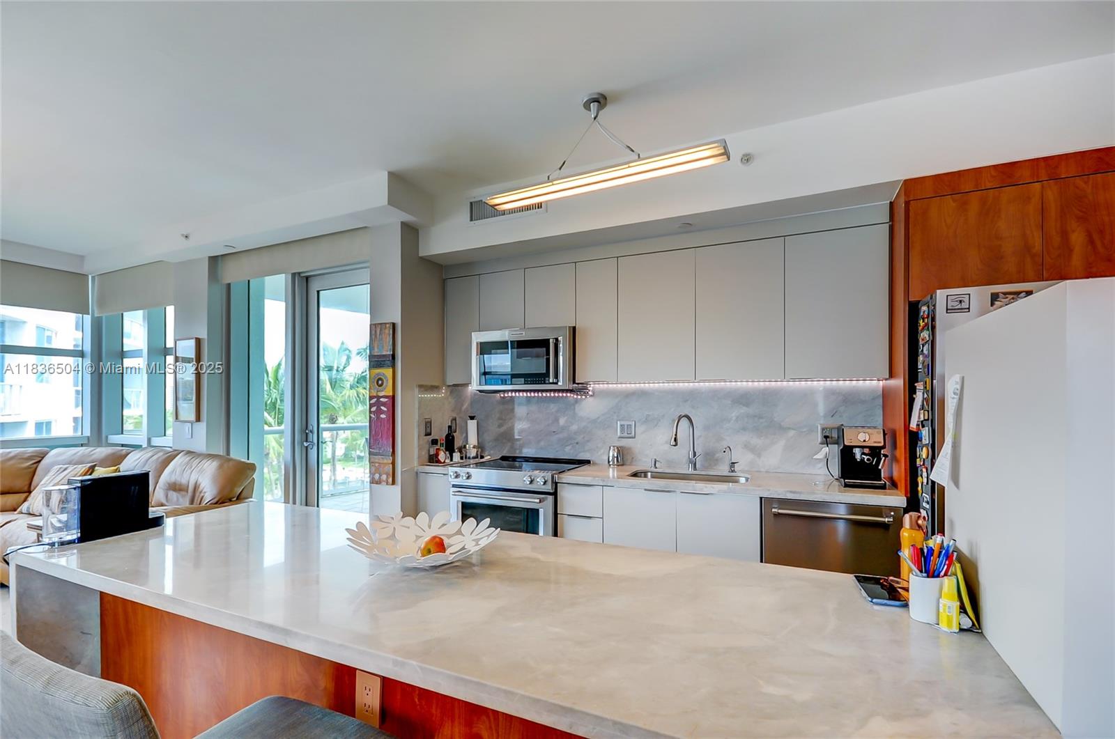 3131 Northeast 188th Street, Unit 1808 Aventura, FL 33180 - Photo 15 of 72 a kitchen with stainless steel appliances a stove a sink and a refrigerator