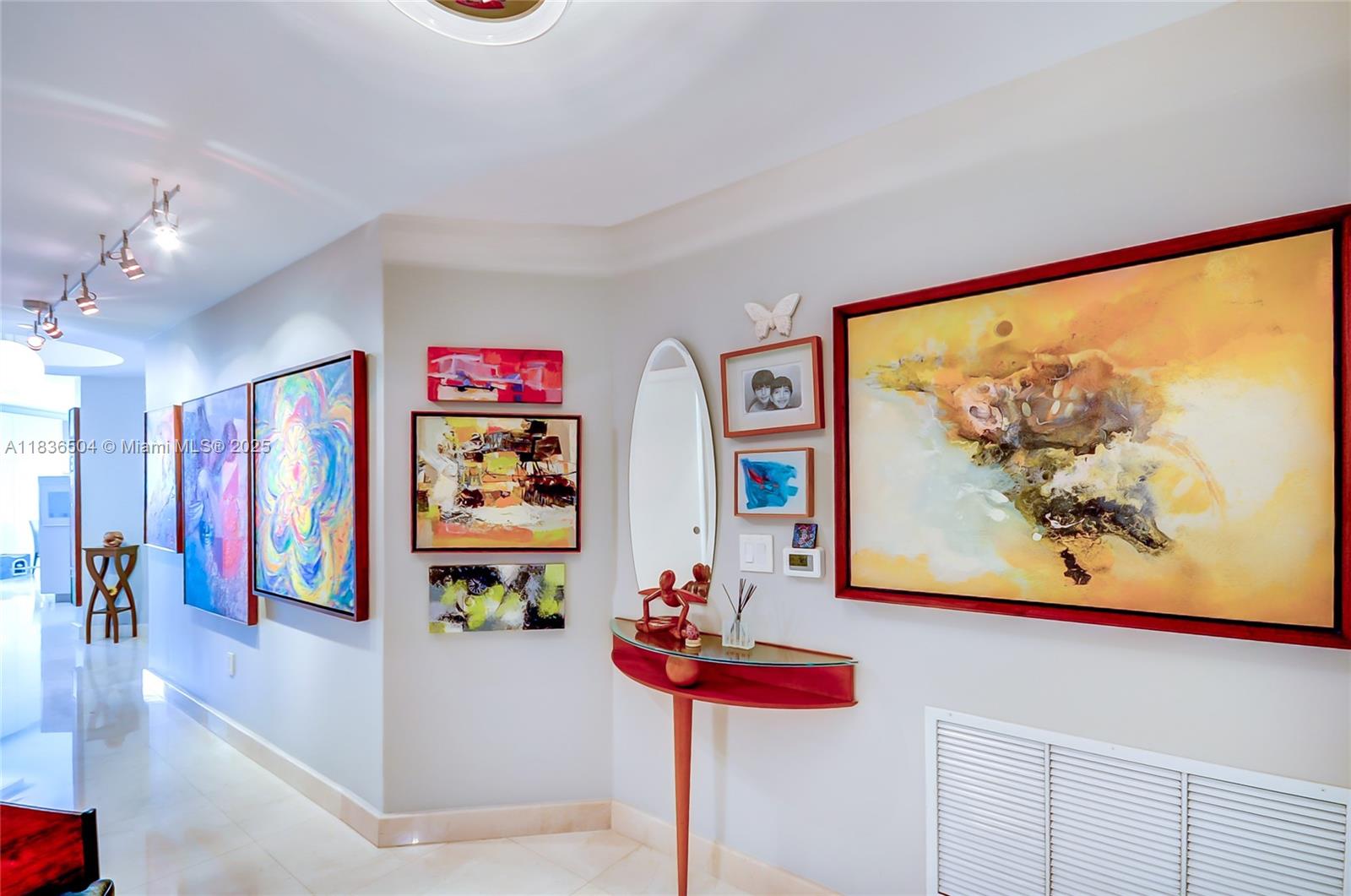 3131 Northeast 188th Street, Unit 1808 Aventura, FL 33180 - Photo 24 of 72 a view of a hallway with painting on the wall and a large window