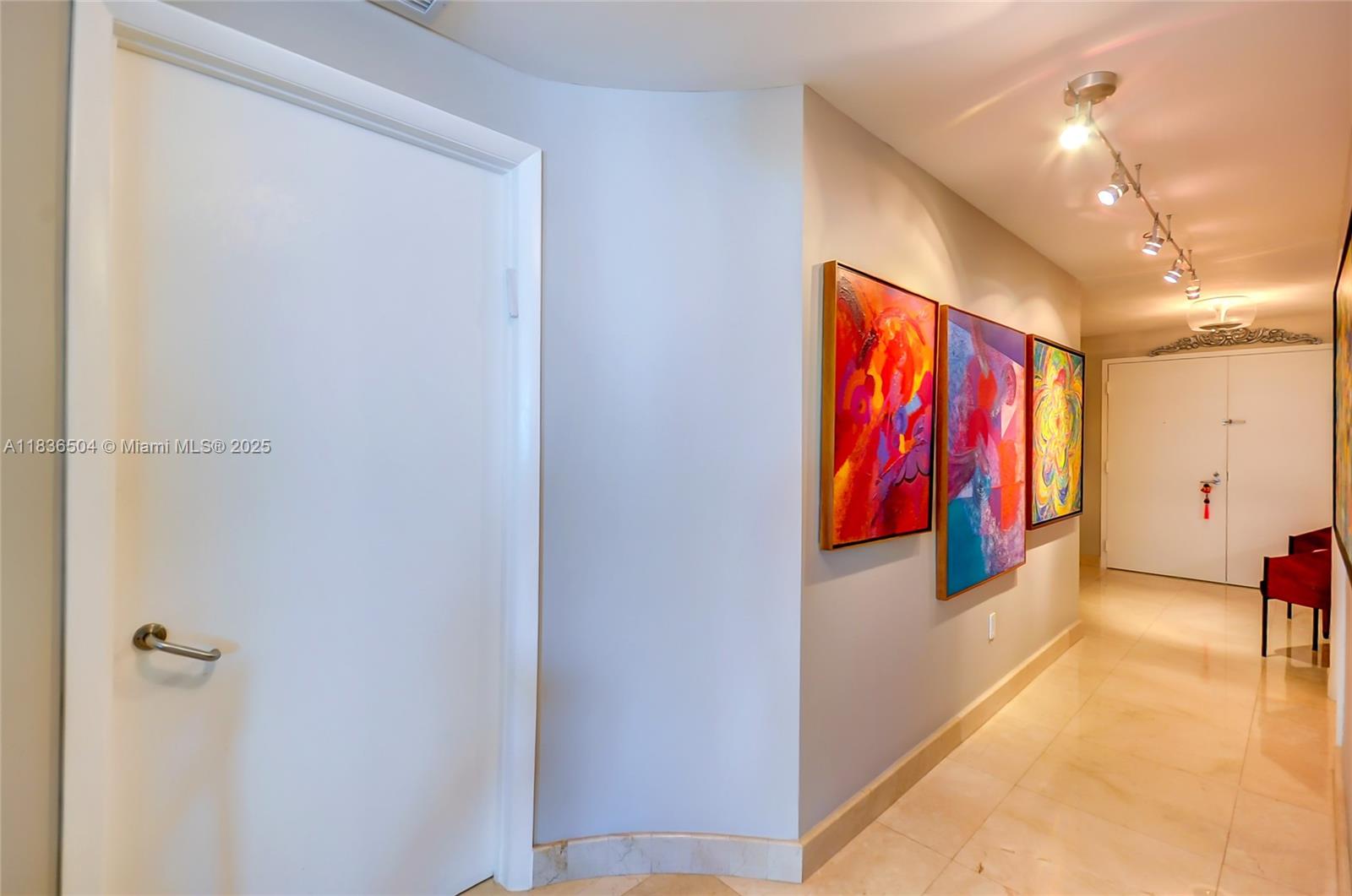 3131 Northeast 188th Street, Unit 1808 Aventura, FL 33180 - Photo 26 of 72 a view of a hallway with paintings on the wall