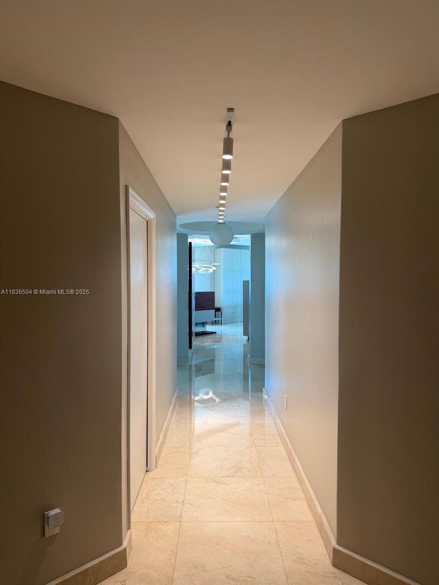 3131 Northeast 188th Street, Unit 1808 Aventura, FL 33180 - Photo 30 of 72 a bathroom with a glass door shower a sink and a mirror