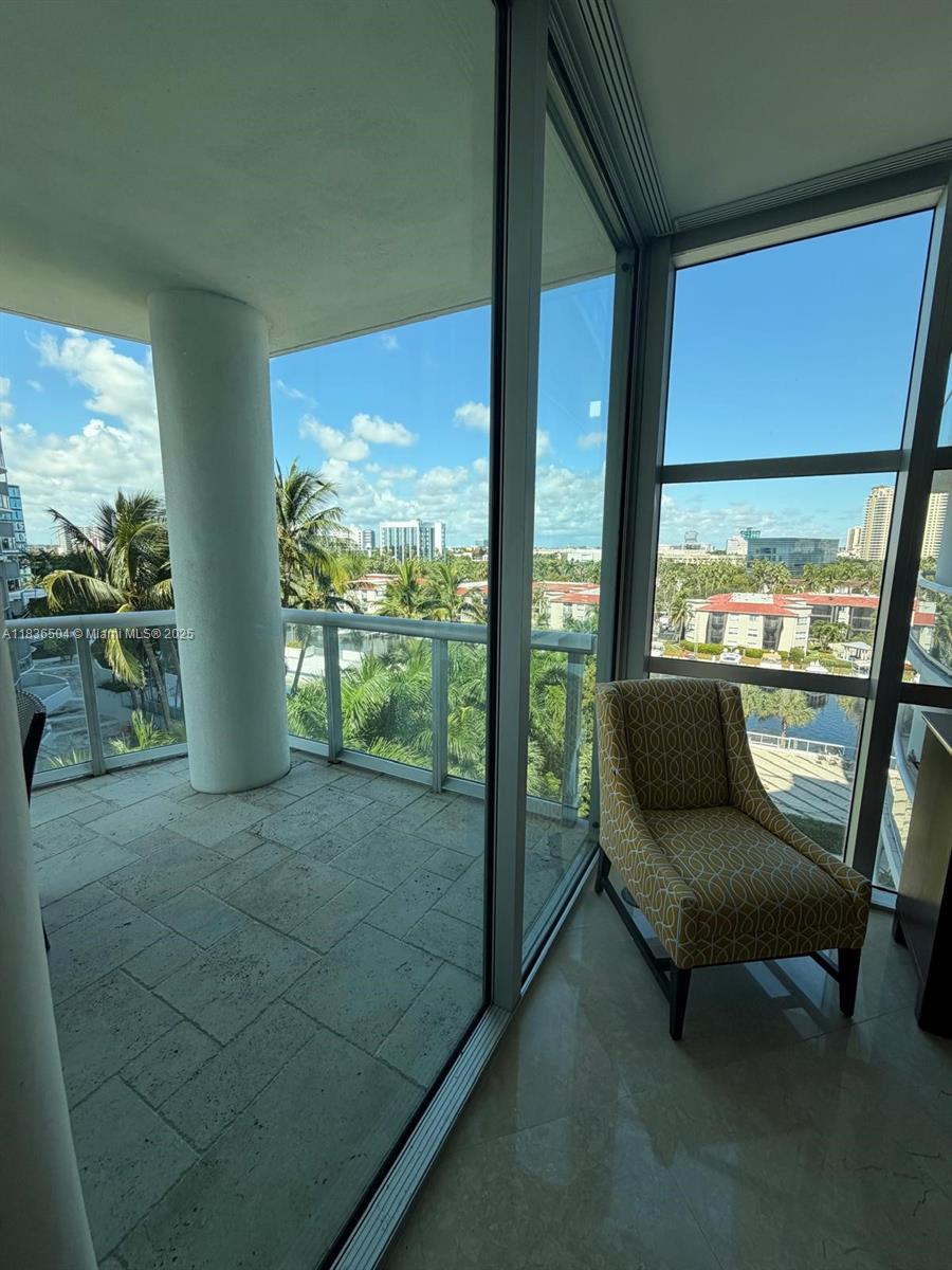3131 Northeast 188th Street, Unit 1808 Aventura, FL 33180 - Photo 33 of 72 a living room with large windows
