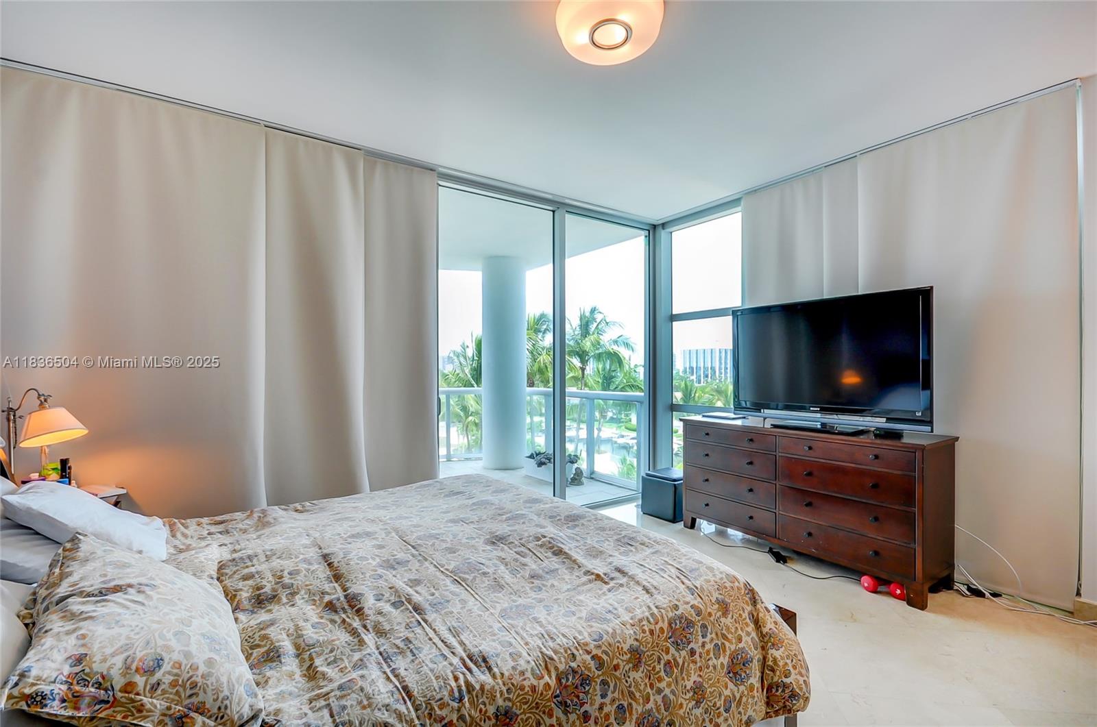 3131 Northeast 188th Street, Unit 1808 Aventura, FL 33180 - Photo 36 of 72 a bedroom with a bed and a flat screen tv
